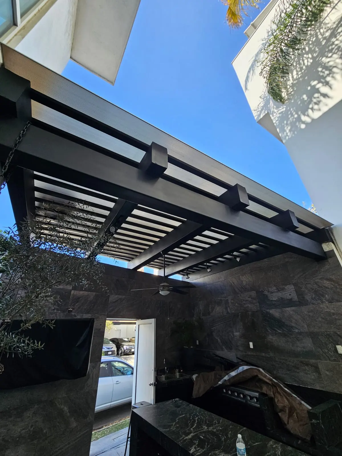 Estructura metálica y policarbonato vistos desde el patio